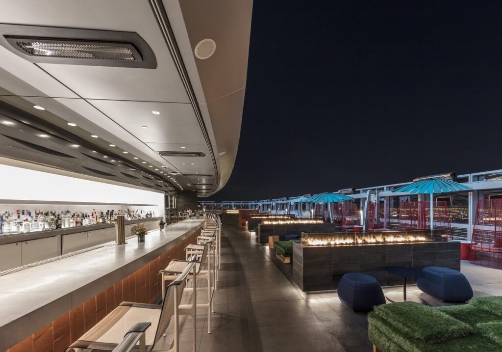 Bar and outdoor drinking area at night with electric heaters