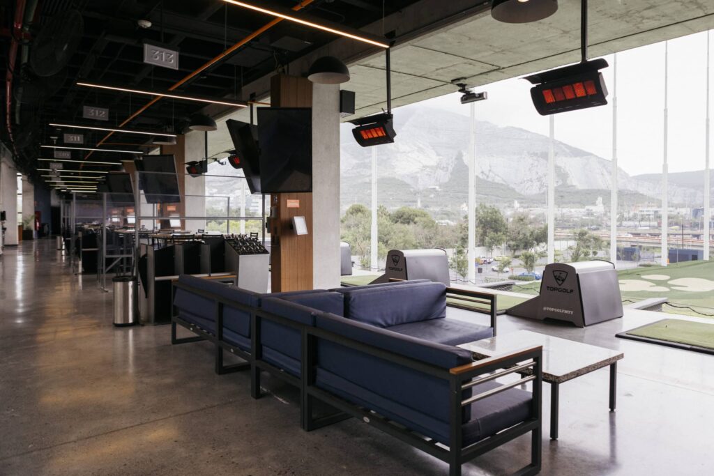 Driving range lounge area with views of mountains and Gas heaters